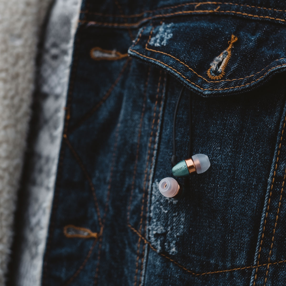 Photo of Grado gr10e headphones hanging from the button of a jean jacket pocket