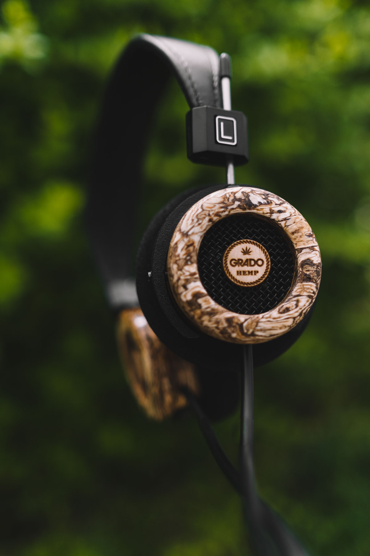 Side view photo of The Hemp Headphones in front of greenery