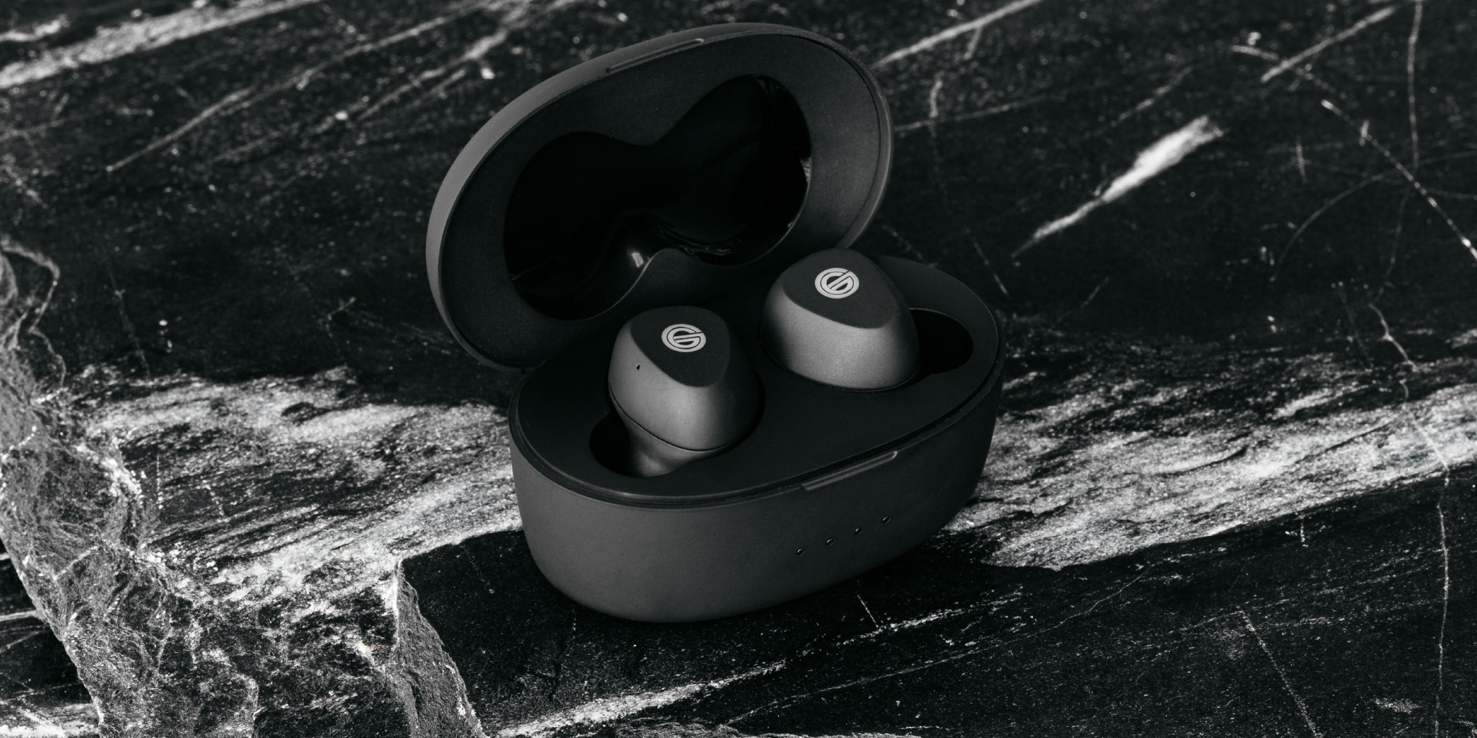 Photo of GT220 Headphones in a black case sitting on a black marble table
