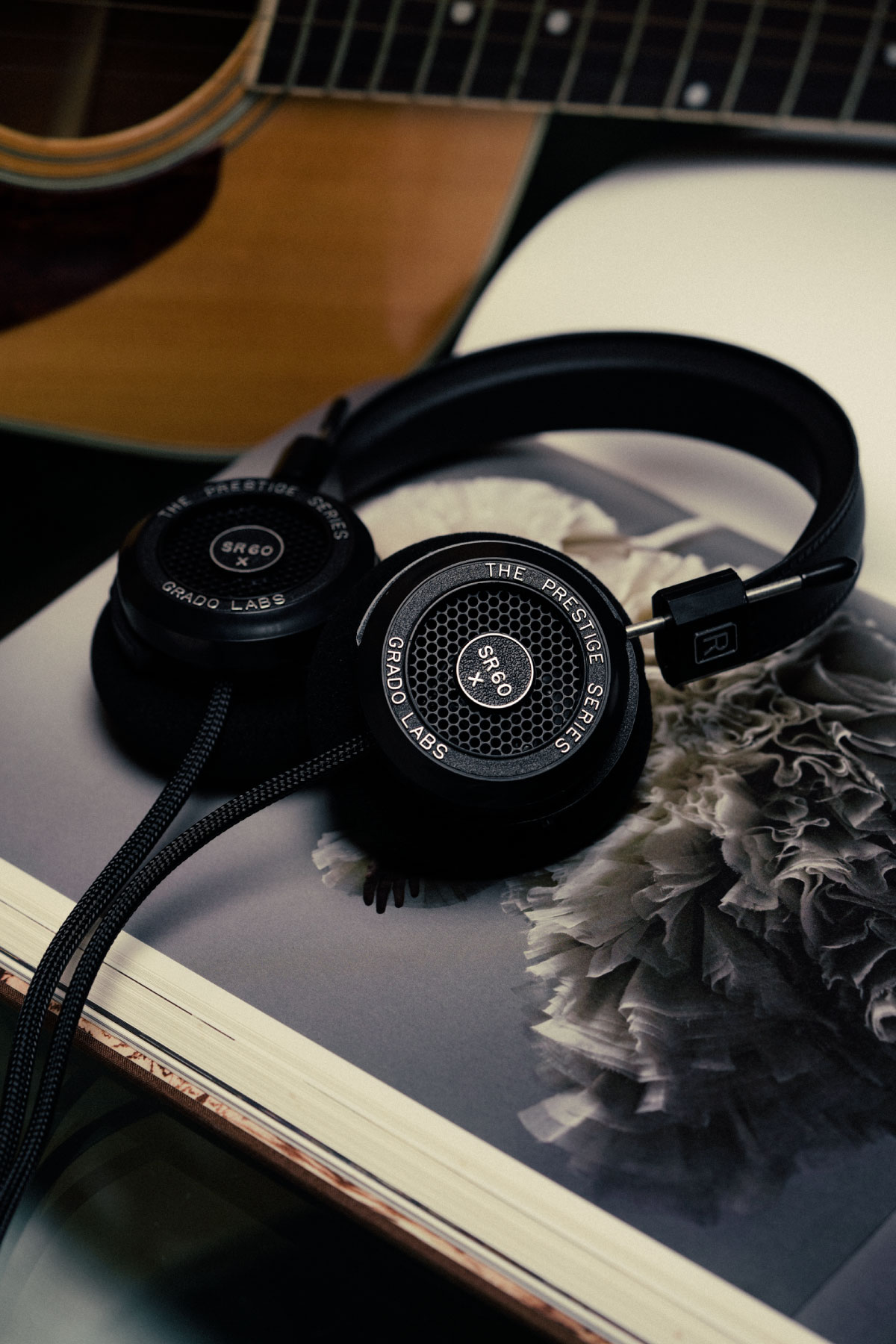 Photo of SR60x headphones resting on an open photo book