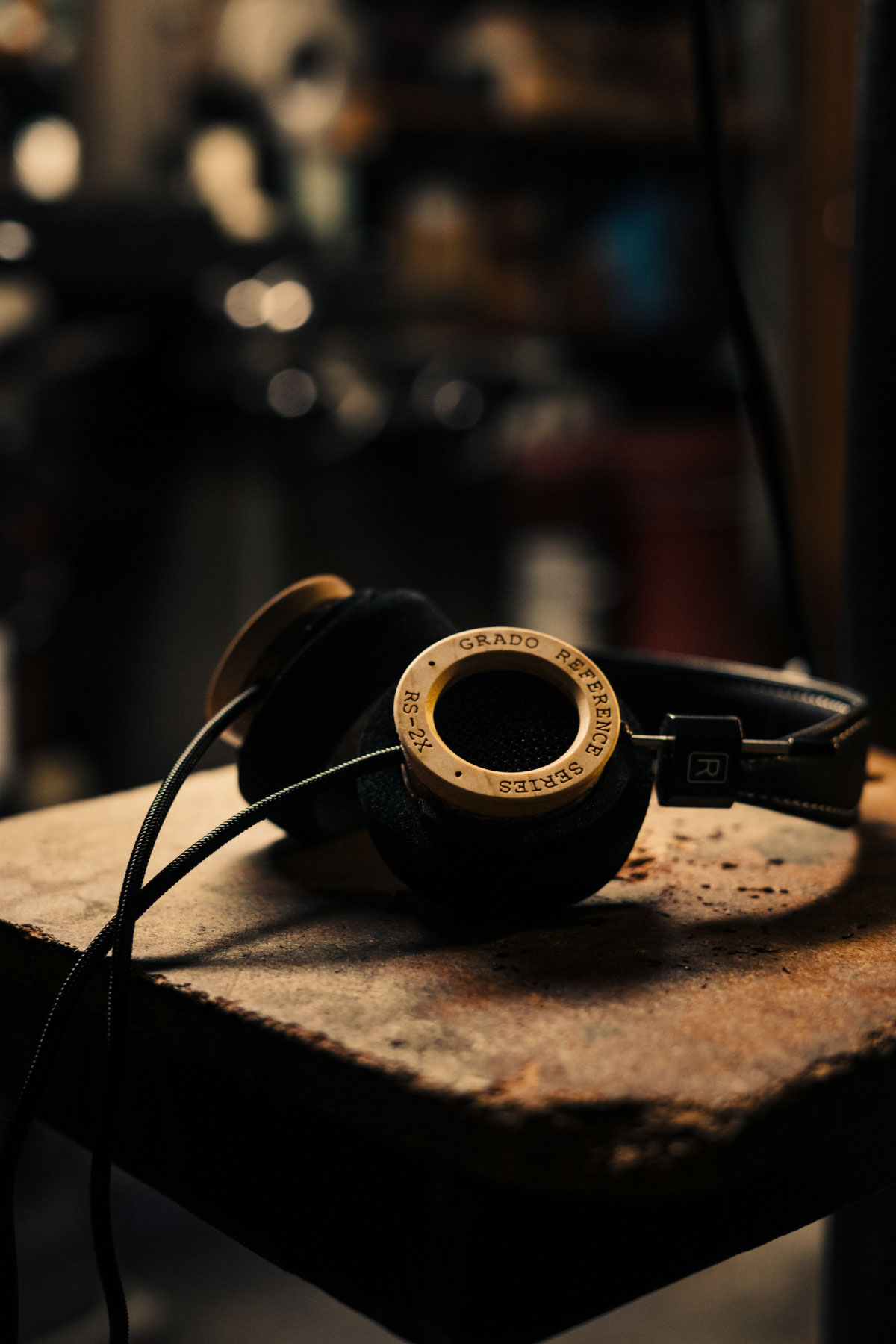Photo of RS2X headphones on top of an old wooden desk